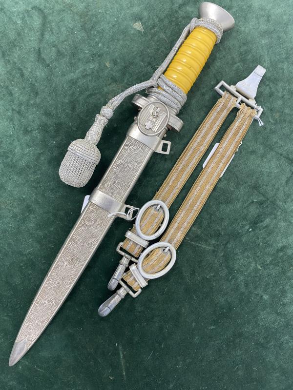 RED CROSS OFFICERS DAGGER WITH ORIGINAL HANGERS AND ORIGINAL KNOT. .