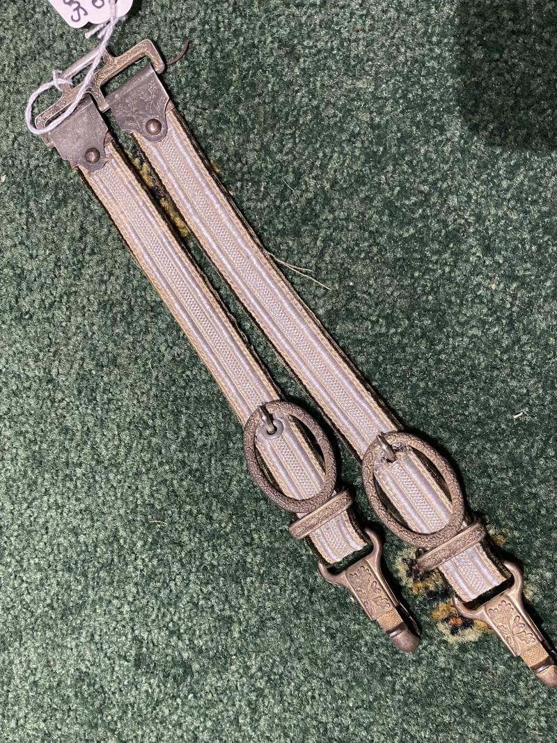 A DE-LUXE PAIR OF ARMY DAGGER HANGERS WITH METAL SWING TOPS.
