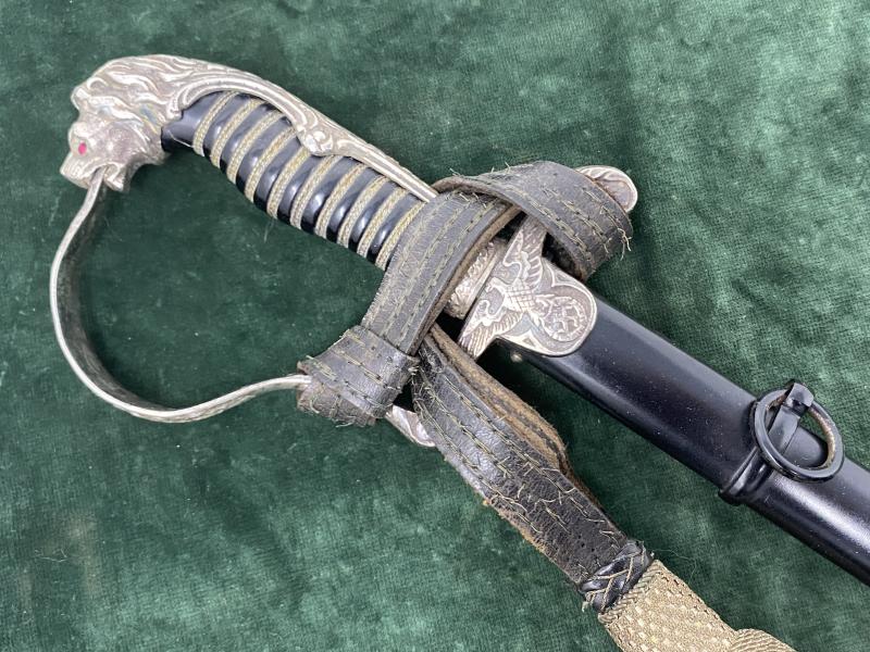 A RARE AND DOCUMENTED EARLY SILVER HILTED LIONS HEAD SWORD USED BY SS OFFICERS.
