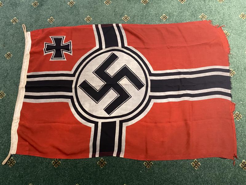 A PROPER ‘BATTLE FLOWN’ REICHSKRIEGSFLAG WITH FULL MARKINGS.