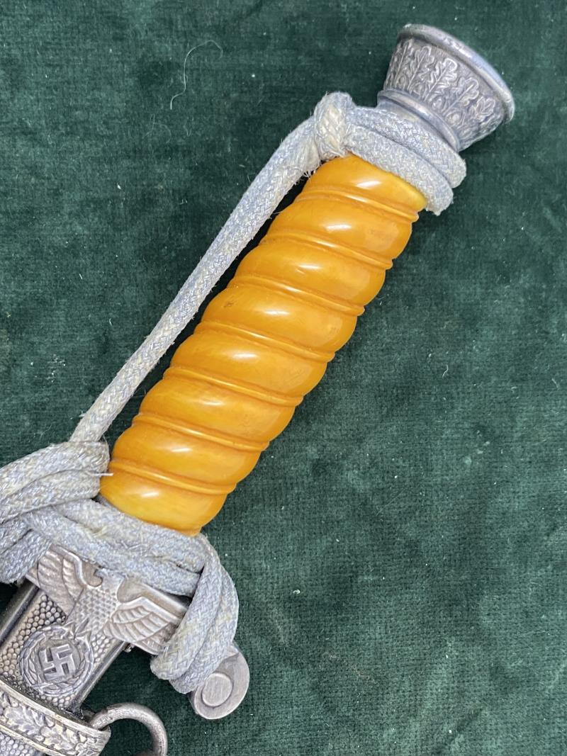 A PERSONALISED/NAMED ARMY DAGGER IDENTIFIED TO AN OFFICER BY ALCOSO WITH STRAPS AND KNOT.