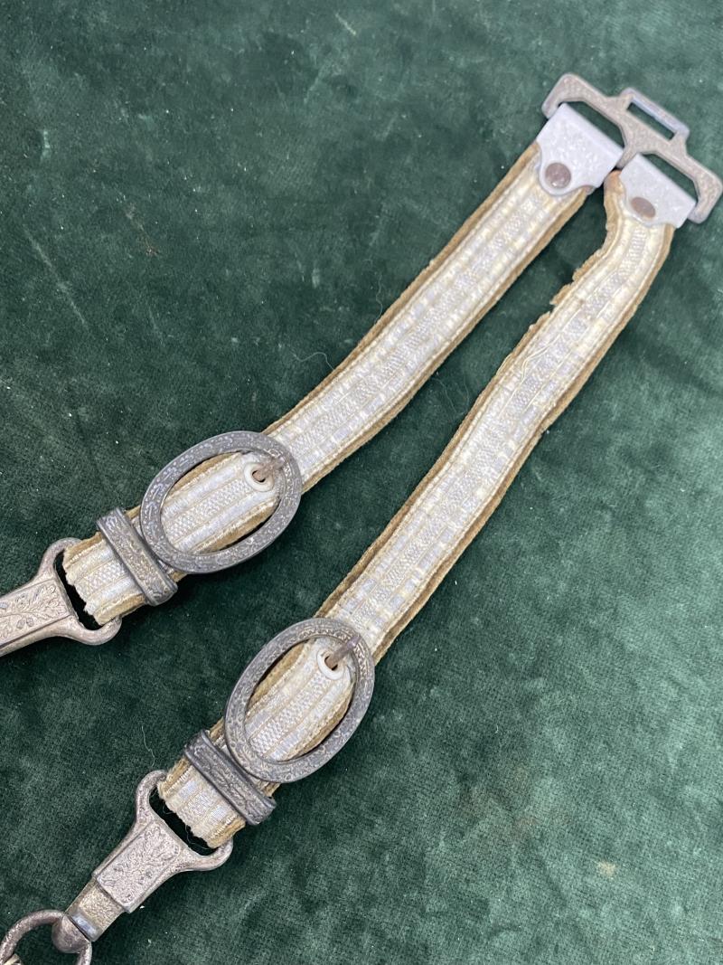 A PERSONALISED/NAMED ARMY DAGGER IDENTIFIED TO AN OFFICER BY ALCOSO WITH STRAPS AND KNOT.