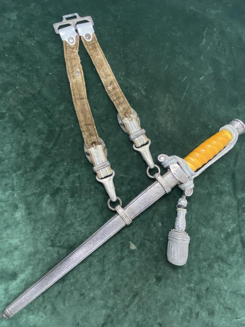 A PERSONALISED/NAMED ARMY DAGGER IDENTIFIED TO AN OFFICER BY ALCOSO WITH STRAPS AND KNOT.