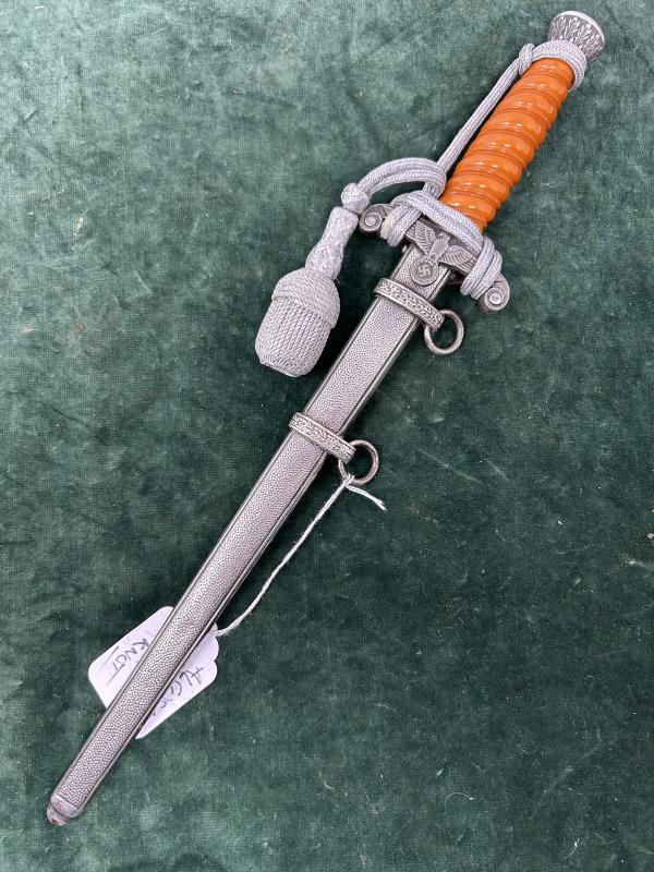 A NEAR MINT ARMY DAGGER BY ALCOSO WITH ORANGE GRIP AND PORTAPEE.