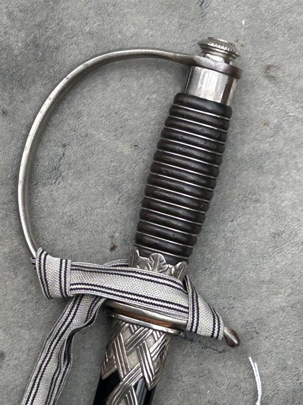 A UNIQUE EXAMPLE OF THE RARE SS ‘OFFICER CANDIDATE’ SWORD WITH INITIALS ON THE BLADE AND SS RUNES IN THE POMMEL.