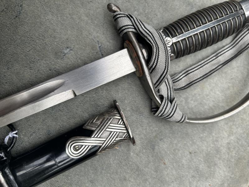 A UNIQUE EXAMPLE OF THE RARE SS ‘OFFICER CANDIDATE’ SWORD WITH INITIALS ON THE BLADE AND SS RUNES IN THE POMMEL.