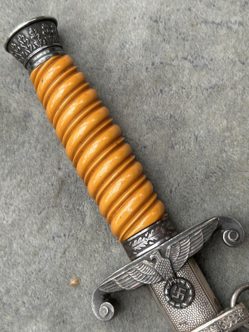 A VERY NICE ARMY OFFICERS DAGGER WITH ORANGE GRIP AND DISTRIBUTOR MARKED BLADE.