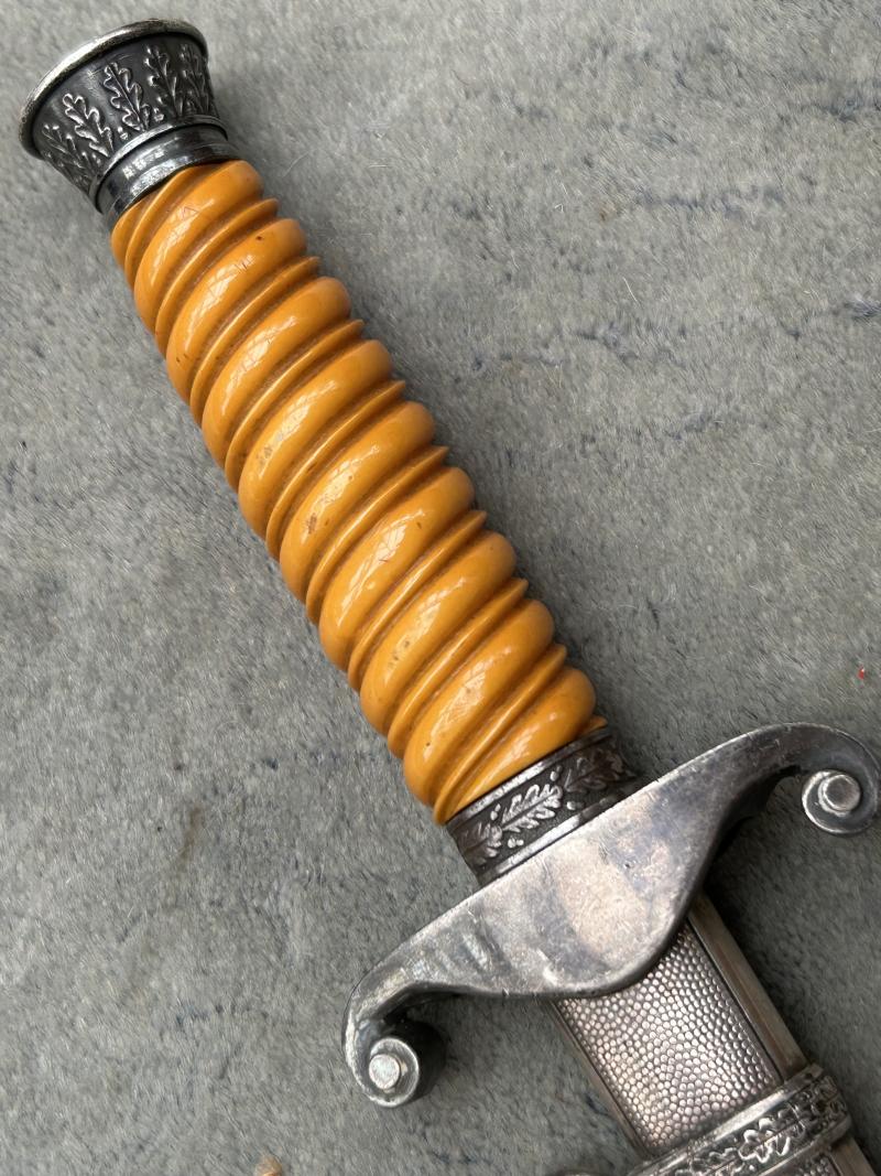 A VERY NICE ARMY OFFICERS DAGGER WITH ORANGE GRIP AND DISTRIBUTOR MARKED BLADE.