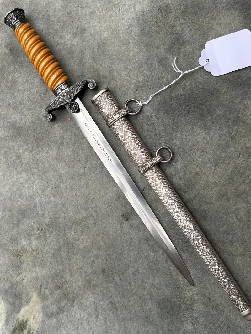 A VERY NICE ARMY OFFICERS DAGGER WITH ORANGE GRIP AND DISTRIBUTOR MARKED BLADE.