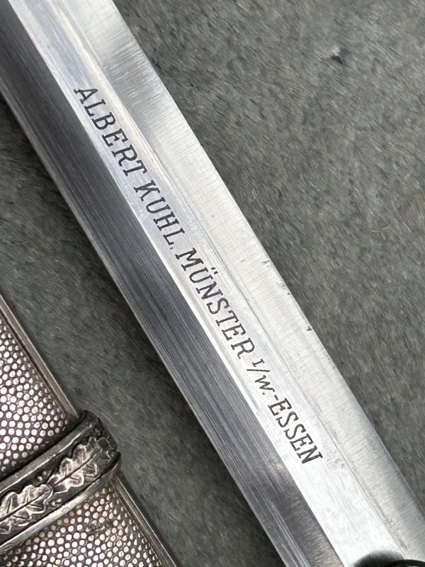 A VERY NICE ARMY OFFICERS DAGGER WITH ORANGE GRIP AND DISTRIBUTOR MARKED BLADE.