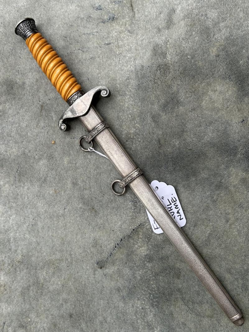 A VERY NICE ARMY OFFICERS DAGGER WITH ORANGE GRIP AND DISTRIBUTOR MARKED BLADE.